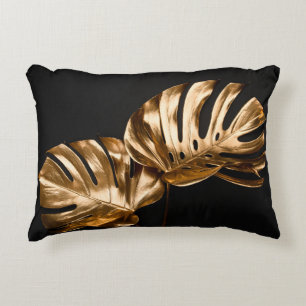 Closeup view of two luxurious golden painted tropi accent pillow
