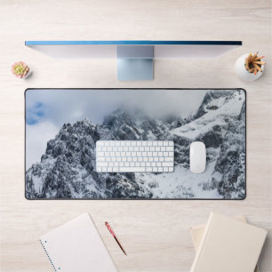 Clouds covering majestic mountains desk mat