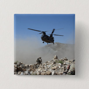 Clouds of dust kicked up by the rotor wash 2 inch square button