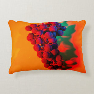 Cluster of blue grape in orange neon light. Food b Accent Pillow