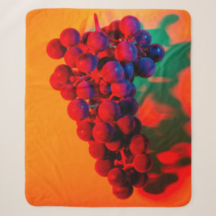 Cluster of blue grape in orange neon light. Food b Sherpa Blanket
