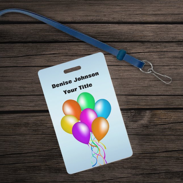Cluster of Colourful Balloons Matching Ribbon Blue Badge (Bunch colourful balloons various colours with streamers on blue ID Badge.)