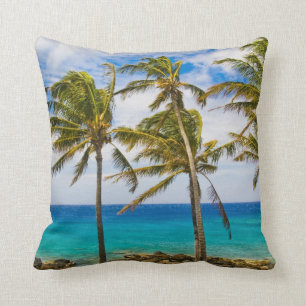 Coconut palm trees (Cocos nucifera) swaying in Throw Pillow