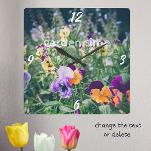 Colorful pansies in a summer country garden square wall clock