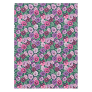 Colorful pansies on dark greenish blue tablecloth