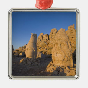 Colossal head statues of Gods guarding the 2 Metal Ornament