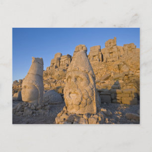 Colossal head statues of Gods guarding the Postcard