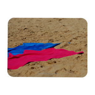 Coloured towels on sandy beach magnet