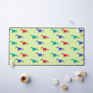 Colourful dinosaurs pattern on green desk mat