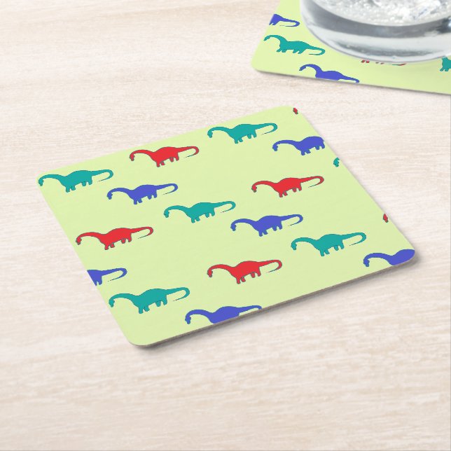 Colourful dinosaurs pattern on green square paper coaster (Angled)
