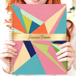 Colourful Geometric Abstract Custom Name Planner<br><div class="desc">This bold design showcases a vibrant geometric abstract pattern with vivid pink, blue, green, and orange tones. The central gold band elegantly highlights a custom name, creating a stylish and personal touch. Perfect for staying organized in school, work, or everyday life, this trendy design combines artistic flair with practicality. Whether...</div>