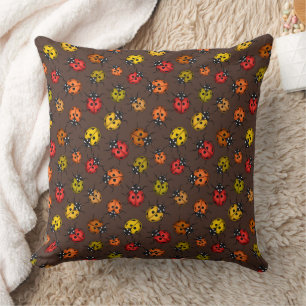 Colourful ladybugs on brown throw pillow
