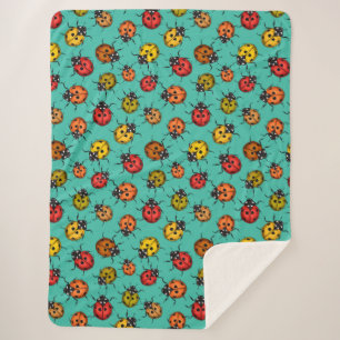 Colourful ladybugs on turquoise sherpa blanket