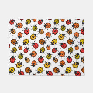 Colourful ladybugs on white doormat