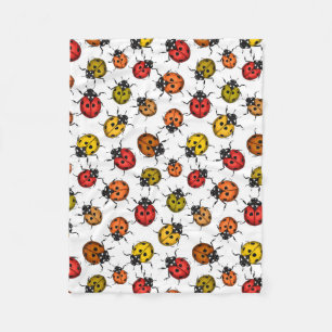 Colourful ladybugs on white fleece blanket