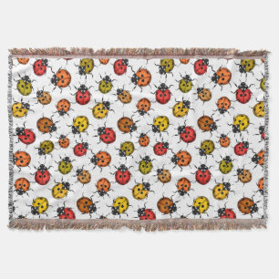 Colourful ladybugs on white throw blanket