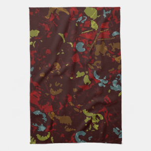 Colourful leaves and flowers against camouflage kitchen towel
