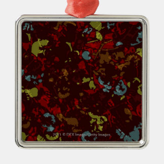 Colourful leaves and flowers against camouflage metal ornament