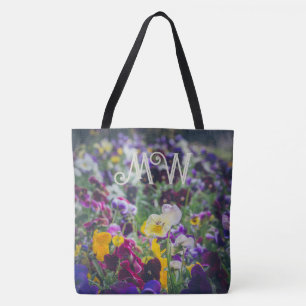 Colourful pansies in bloom in the country garden tote bag