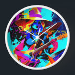 Colourful Pop Art Guitarist Witch Clock<br><div class="desc">The image features a witch playing an electric guitar, portrayed in a vibrant and colourful art style. The witch wears a large, wide-brimmed hat and has flowing, wavy hair in hues of yellow and blue. Her expression is focused and intense as she strums the guitar, which stands out with its...</div>