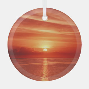 Colourful sunrise at sea, dramatic clouds. glass ornament