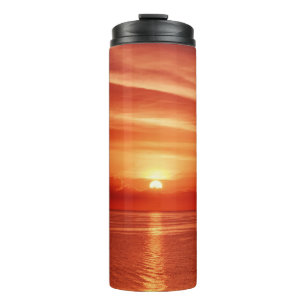 Colourful sunrise at sea, dramatic clouds. thermal tumbler