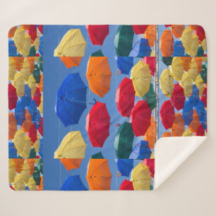 Colourful umbrellas in the sky blue orange red sherpa blanket