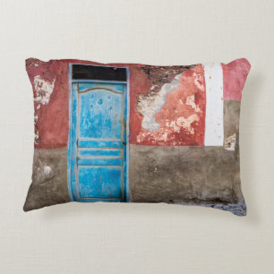 Colourful wall with blue door accent pillow
