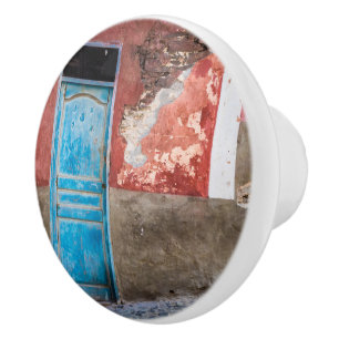 Colourful wall with blue door ceramic knob