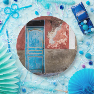 Colourful wall with blue door paper plate