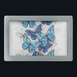 Composition of White and Blue Butterflies Belt Buckle<br><div class="desc">Vertical composition of realistic,  blue and white morpho butterflies on grey textured background. Morpho blue butterfly.</div>