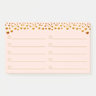 Confettis dorés sur des Post-It rose corail