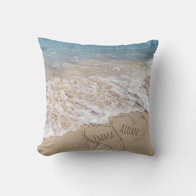 connected hearts in beach sand with ocean surf throw pillow (Front)