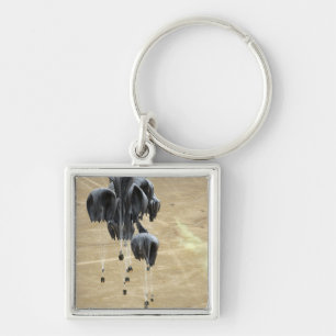 Container delivery system bundles parachute keychain