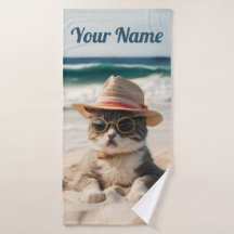 Cool cat on the beach with sunglasses and hat.