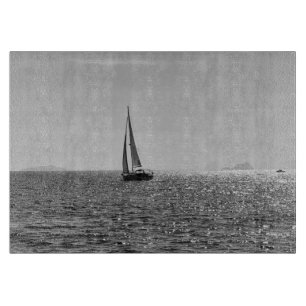 Cool modern photo of sail boat in summer cutting board