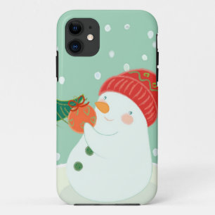 Coque iPhone 11 Un bonhomme de neige accrochant un ornement sur un