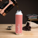 Coral Personalized Wedding Bridesmaid Water Bottle<br><div class="desc">Gift your wedding bridesmaid or maid of honour with this trendy, vacuum Insulated water bottle that features her name in white, stylized script on a coral colour background designed to match your wedding colour scheme . Personalize bottle by editing and replacing name with your own as desired. Select your water...</div>