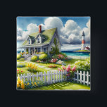 Cottage With View Of The Lighthouse 2 Inch Square Button<br><div class="desc">A dreamy coastal cottagecore landscape filled with soft watercolor charm and breezy seaside tranquility. A welcoming seaside cottage sits among lush garden paths, blooming flowers, and a bright white picket fence, creating a warm storybook atmosphere. In the distance, a tall lighthouse rises beside sparkling blue ocean waves, adding a classic...</div>