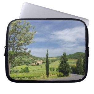 Country road curving between cypress trees in laptop sleeve