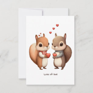 Couple d'écureuil tenant une carte de maïs