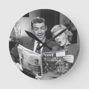 Couple Reading Magazine Round Clock
