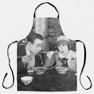 Couple sharing a noodle in a restaurantvintage, fo apron