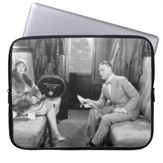 Couple sitting together in a compartment of a trai laptop sleeve