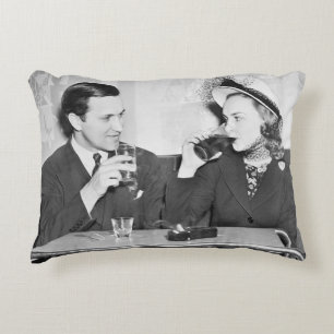Couple sitting together in a restaurant flirting w accent pillow