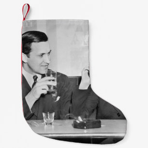 Couple sitting together in a restaurant flirting w small christmas stocking