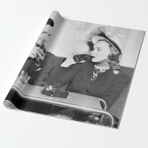 Couple sitting together in a restaurant flirting w wrapping paper