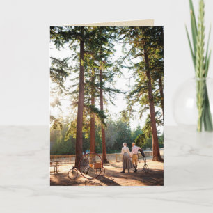 Couple walking in sunshine with Victorian cycles Card