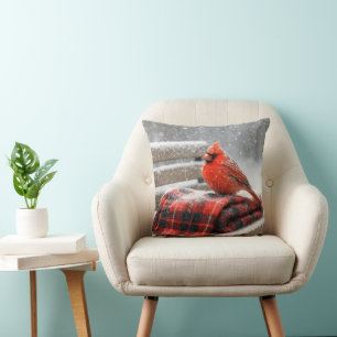 Coussin Cardinal rouge de Noël sur une couverture à carrea