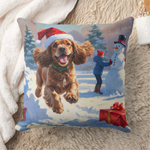 Coussin Cocker Spaniel courant dans la neige avec un chape